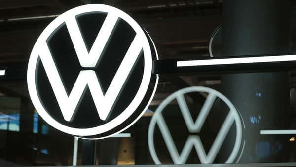 A Volkswagen (VW) logo sits on display in the visitors area of the Volkswagen AG e-Golf electric automobile factory in Dresden, Germany.