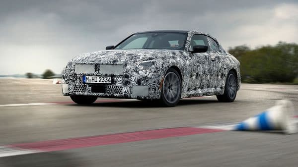 The 2022 BMW 2 Series Coupé covered in camouflage.