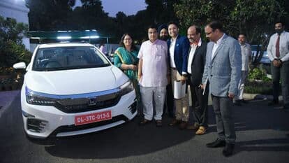 Union Minister Nitin Gadkari seen next to the new Honda City Hybrid sedan. He is flanked by Honda Cars India officials who met him recently. (Photo courtesy: Twitter/@HondaCarIndia)