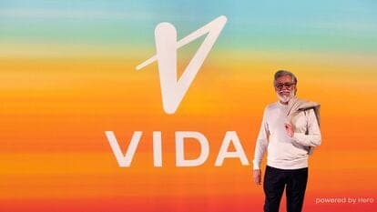 Pawan Munjal, Chairman and CEO at Hero MotoCorp, standing next to Vida branding which represents the group's new electric vehicle business.
