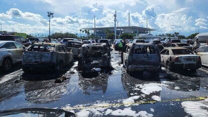 An image showing various vehicles charred by fire in the Hard Rock Stadium parking lot
