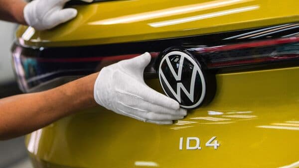An employee carries out final quality checks on a Volkswagen ID.4 SUV at its EV facility in Zwickau, Germany.