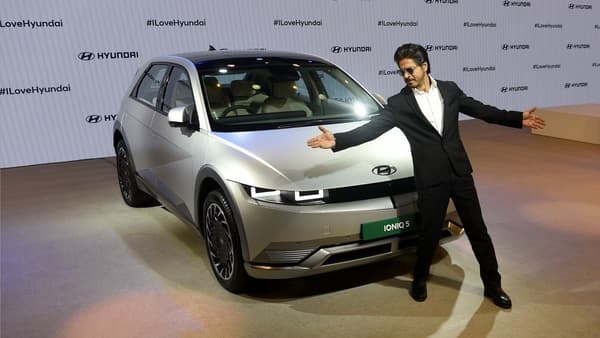 Bollywood showman Shah Rukh Khan in his iconic pose in front of Hyundai's showstopper Ioniq 5 at the Auto Expo 2023.