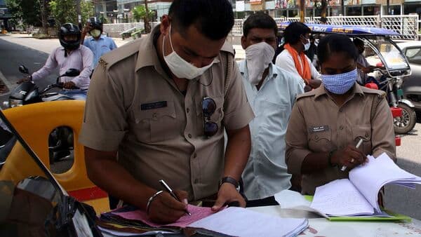 Police personnel fine a motorist in Noida. (Representational photo)