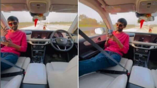 Screengrab from the viral video of a man inside a moving Mahindra XUV700 shows how people are misusing ADAS system on vehicles.