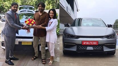 Telugu actor Nagarjuna and his wife Amala pose in front of the brand new Kia EV6 they bought recently.