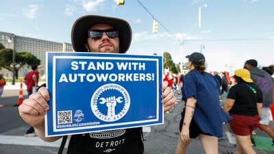 United Auto Workers members and others gather for a rally after marching in the Detroit Labor Day Parade. The UAW is currently in contract negotiations with the Big Three automakers Ford, General Motors, and Stellantis.