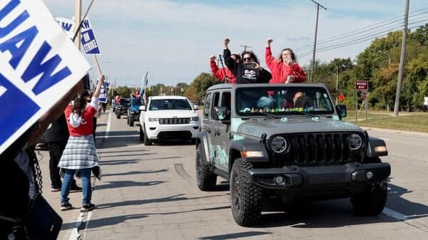A caravan of striking United Auto Workers from the Jeep plant in Toledo, Ohio, drive past striking Ford UAW members in solidarity outside the Ford Michigan Assembly Plant.
