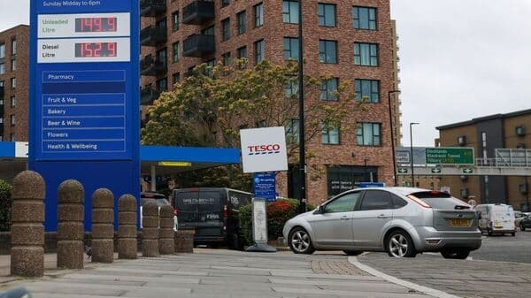 A totem sign displays petrol and diesel prices at a Tesco petrol station in London. UK Prime Minister has decided to extend the deadline to ban petrol cars by five years to 2035.