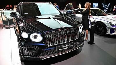File photo: A visitor takes photos of the Bentley Bentayga EWB car at the plant of Audi Hungary.