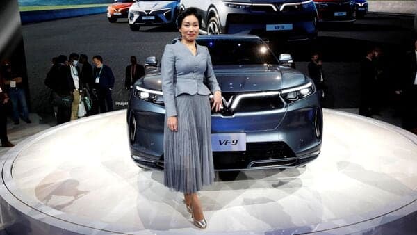 Le Thi Thu Thuy, vice chairwoman of the Vingroup and VinFast Global CEO, poses by a VF9 electric SUV during the unveiling of a line of electric SUVs at CES 2022 at the Las Vegas Convention Center. The EV maker will start building its India facility from February 25, entering the country much ahead of its rival Tesla.