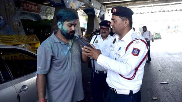Delhi Traffic Police officials conduct checking for drunk driving during Holi festival celebrations. More than 800 people were fined for driving under influence of alcohol.
