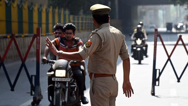 Noida Police checking people violating traffic rules during Holi. More than 8,000 motorists were caught riding without helmet during the festival. (Photo by Sunil Ghosh / Hindustan Times) 