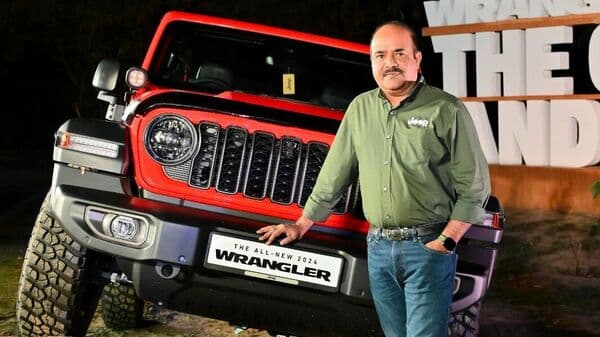 Jeep India Brand Director Priyesh Kumar stands next to the 2024 Jeep Wrangler SUV.