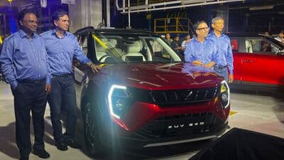 Mahindra officials stand next to the newly-launched XUV 3XO sub-compact SUV.